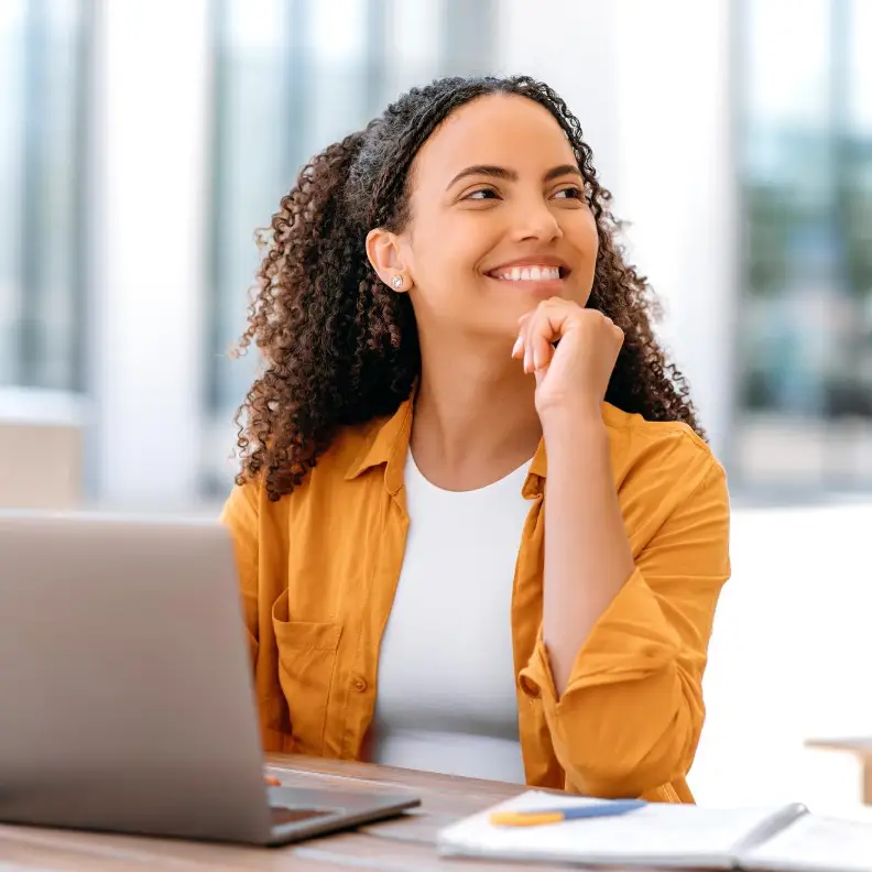 Smiling businesswoman at laptop representing IT consulting and professional services