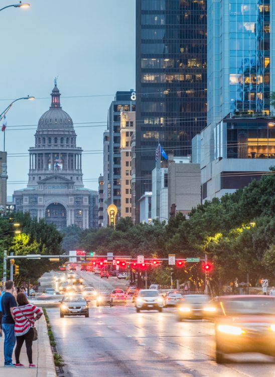 Texas State Capitol building in Austin, showcasing its distinctive pink granite exterior and Renaissance Revival architecture.