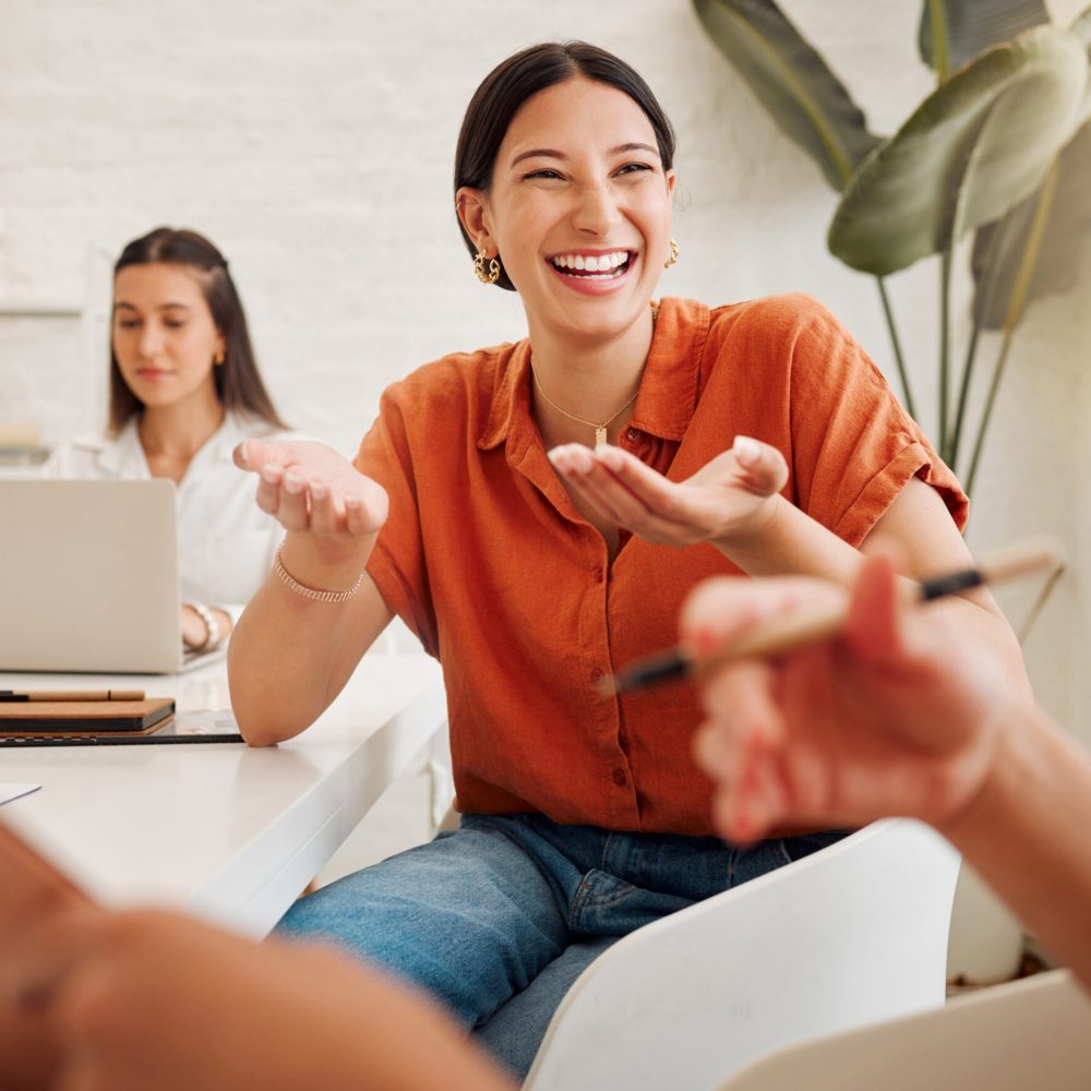 Business professionals in a modern office, laughing and sharing ideas during a creative brainstorming session.